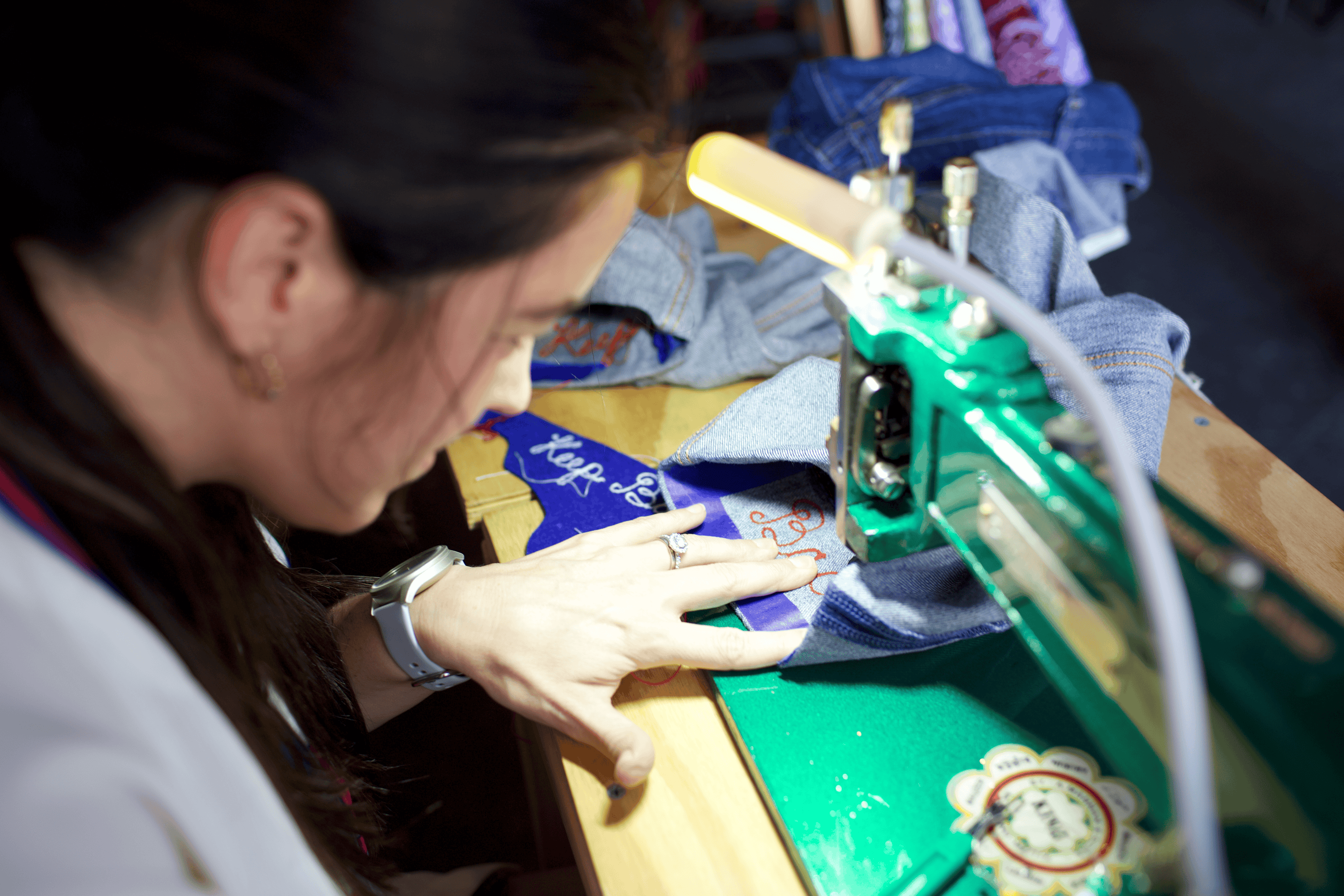 over the shoulder view of live chainstitch embroidery at an event at Cartesian Brewery in South Philadelphia