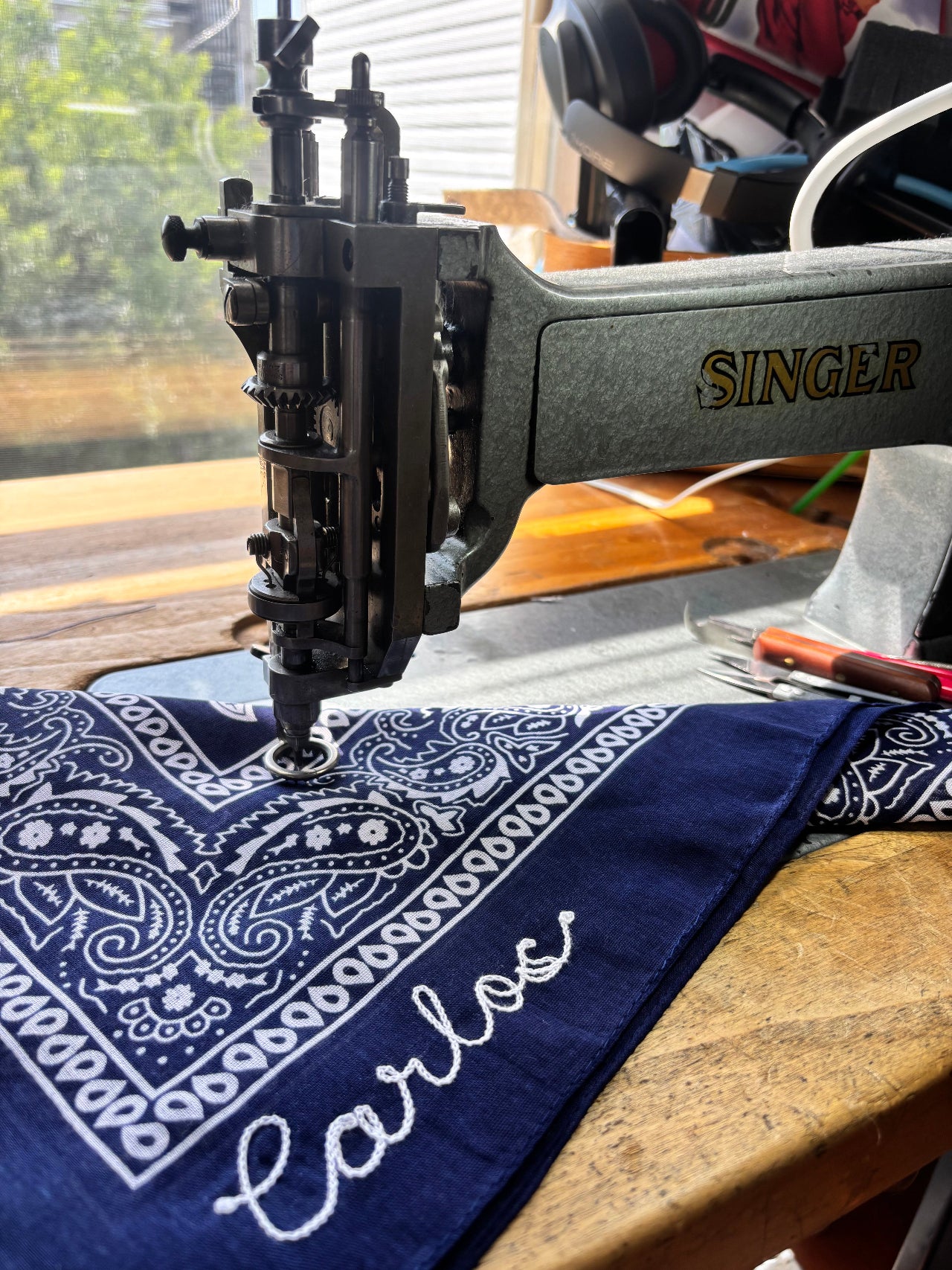 A customized chainstitch embroidered bandana with "Carlos"