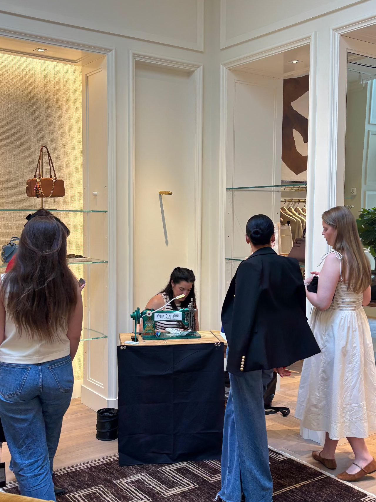chainstitch embroidery retail activation featuring that crafty one and an audience of attendees waiting to get customized