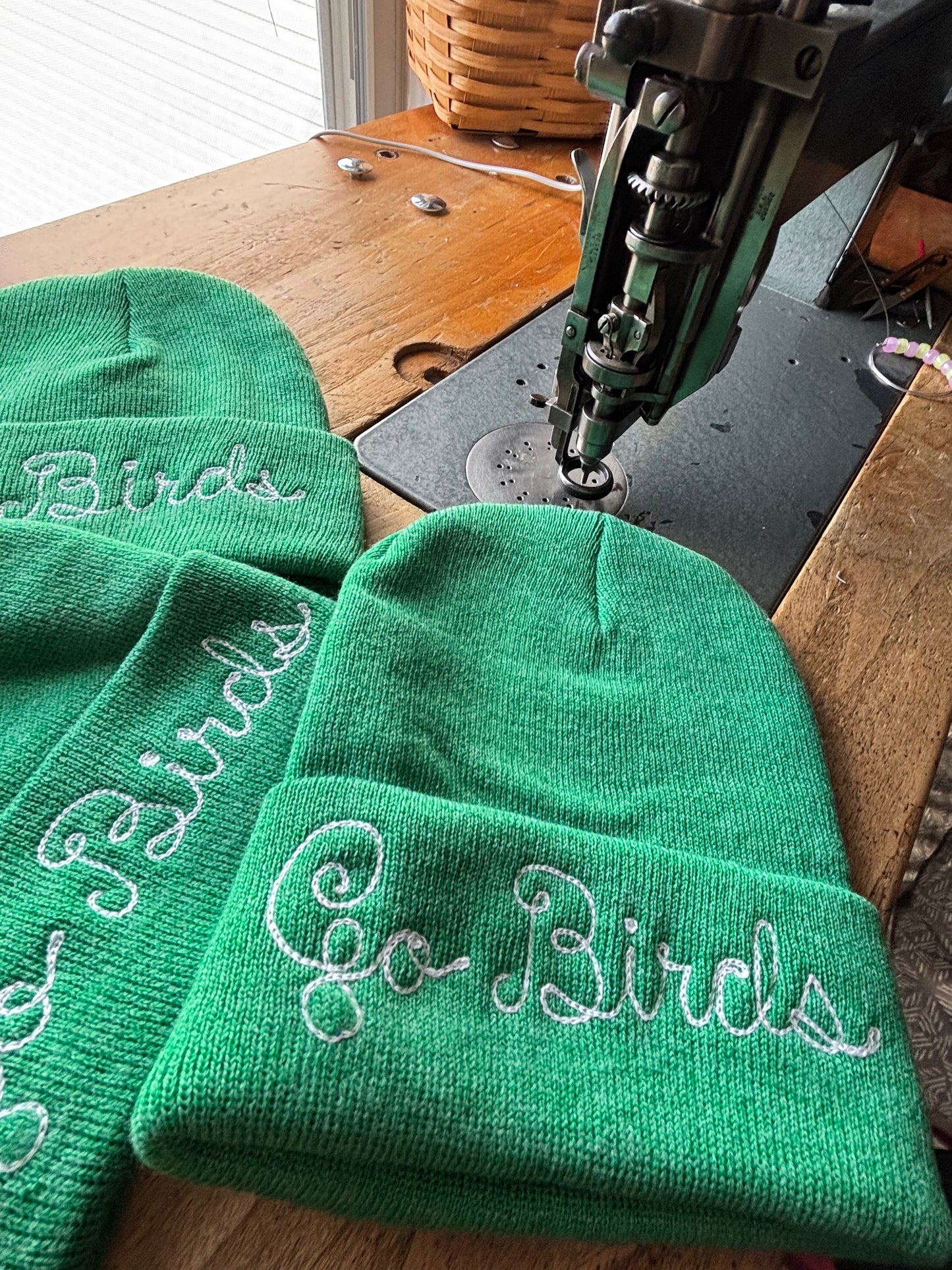 Go Birds heathered kelly green chainstitched beanie representing the Philadelphia Eagles in loopy script embroidery
