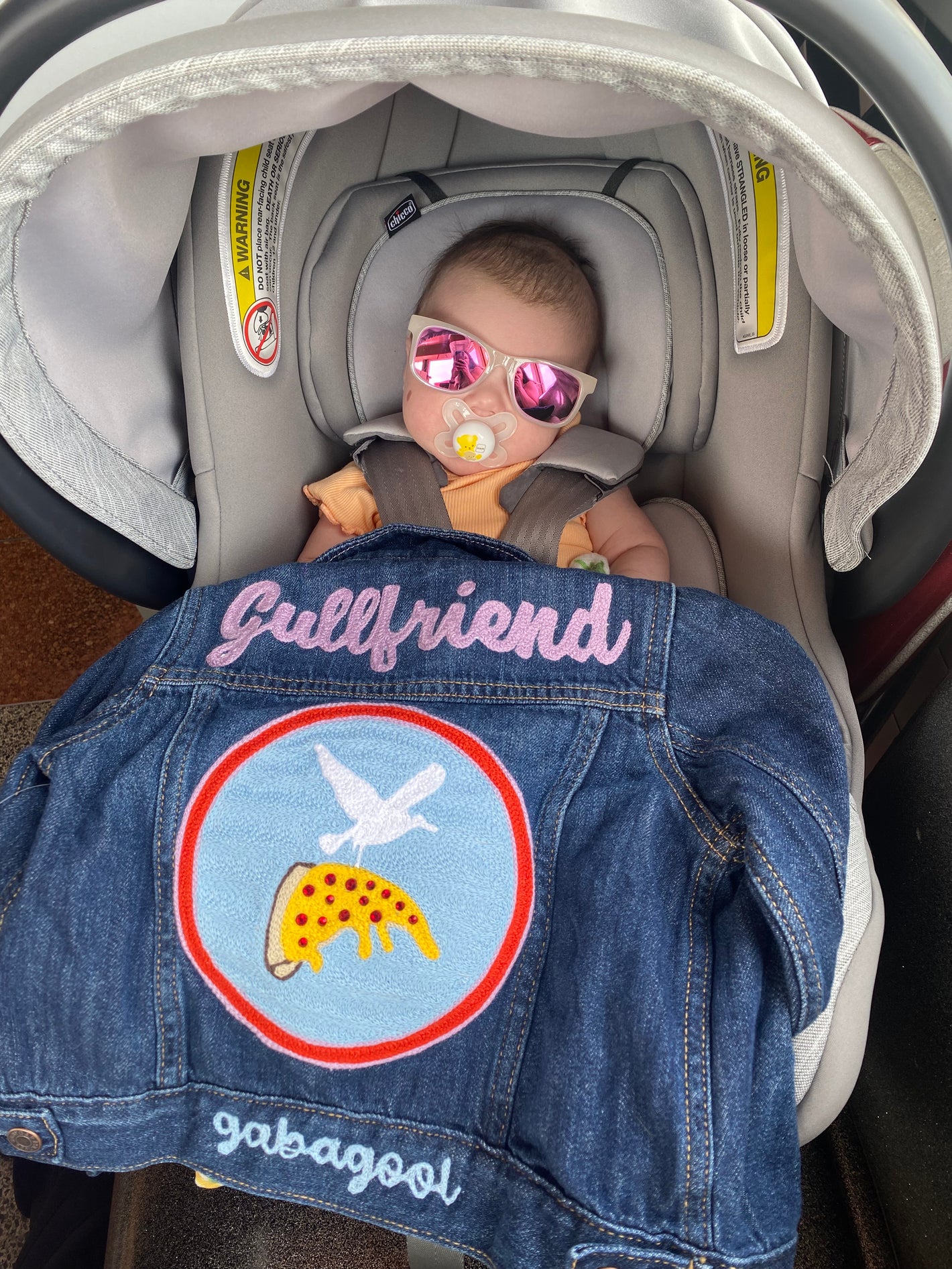 Custom chainstitch embroidered baby jacket with "Gullfriend" on the back and a Jersey Shore seagull flying carrying a slice of pepperoni pizza. Gabagool chainstiched on the bottom hem.