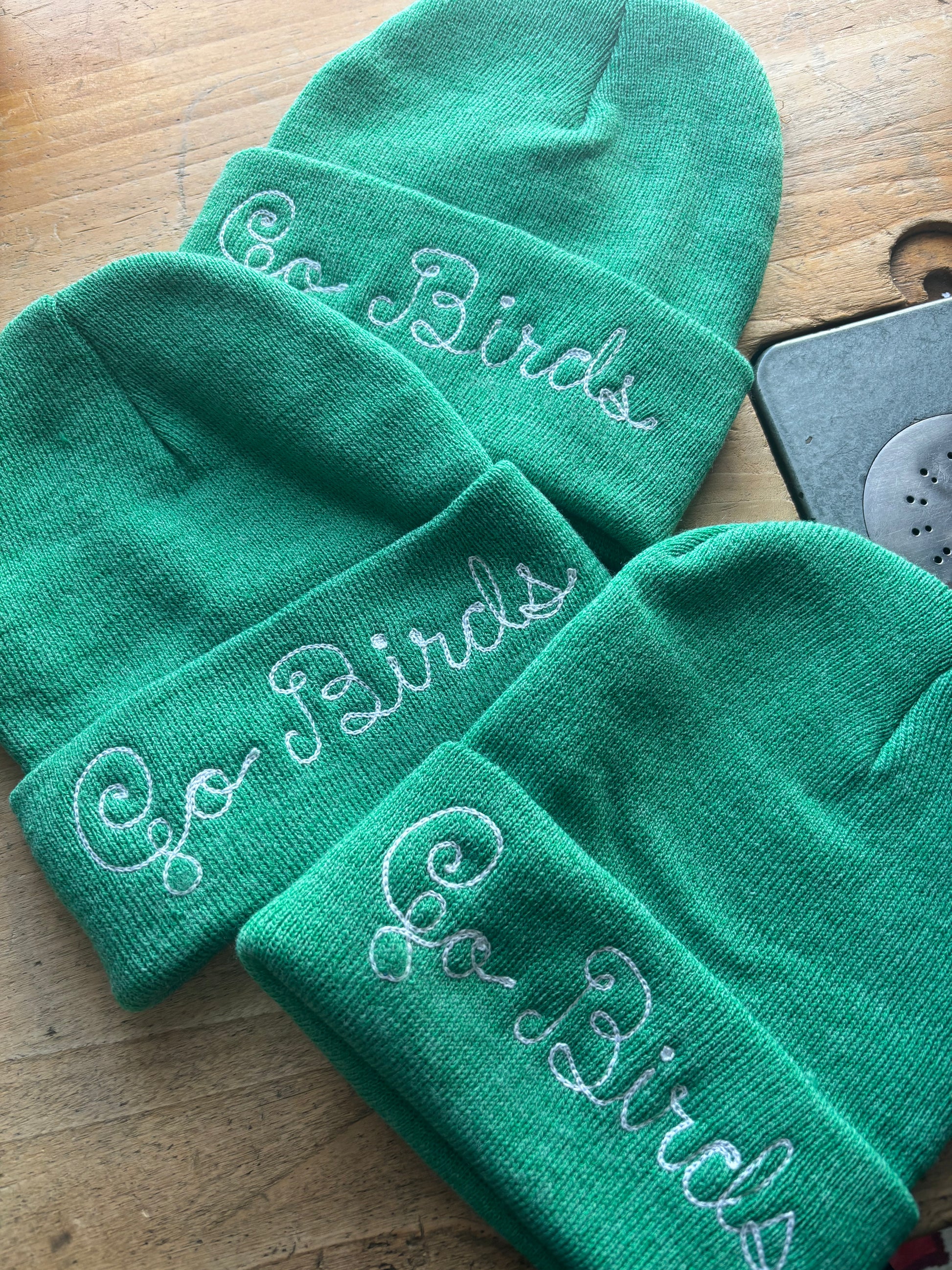 Go Birds heathered kelly green chainstitched beanie representing the Philadelphia Eagles in loopy script embroidery