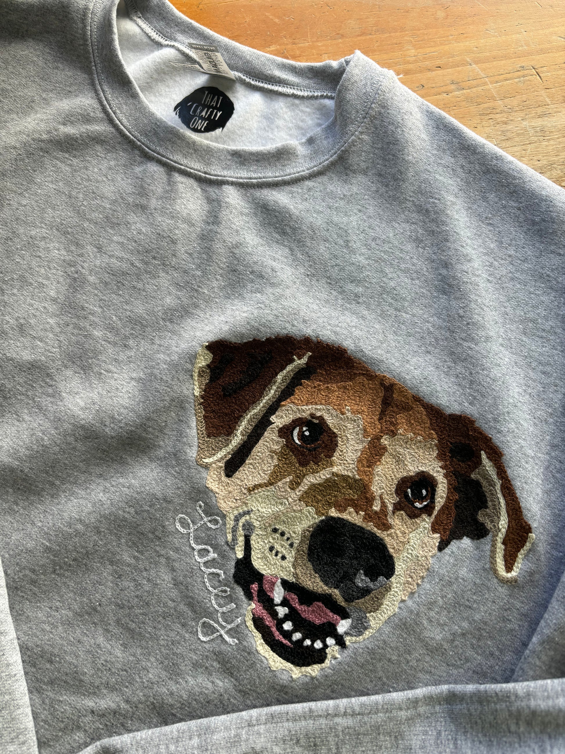 Custom pet portrait of a dog with script embroidery add on of Lacey underneath the embroidered portrait. Done on a hand cranked embroidery machine in Philadelphia.