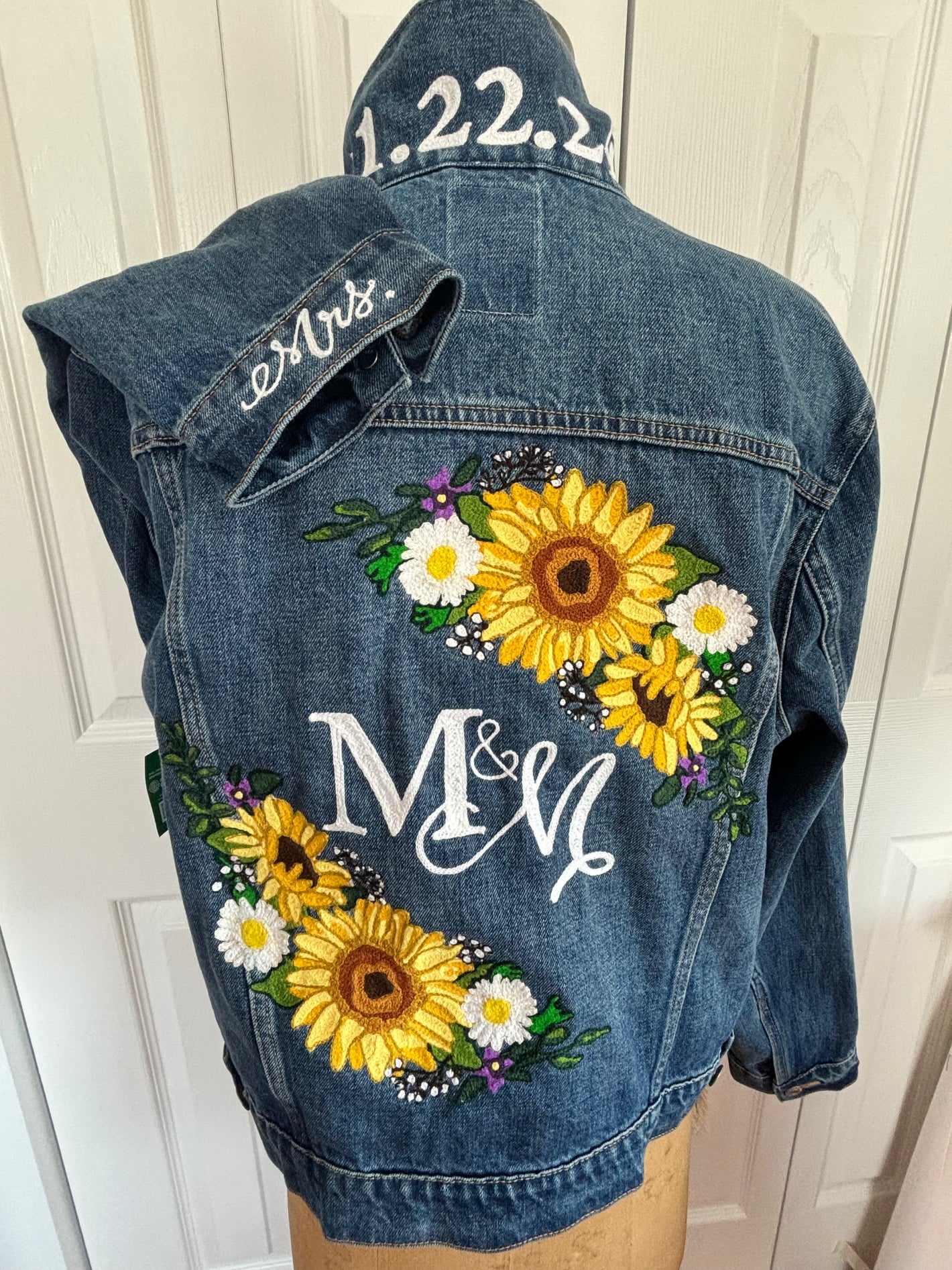 Commissioned custom chainstitch embroiderd wedding jacket featuring sunflower motifs, daisies, a large monogram of M & M. Wedding date is embroidered on the collar and "Mrs." on the cuff. Embroidered for a Philadelphia wedding.