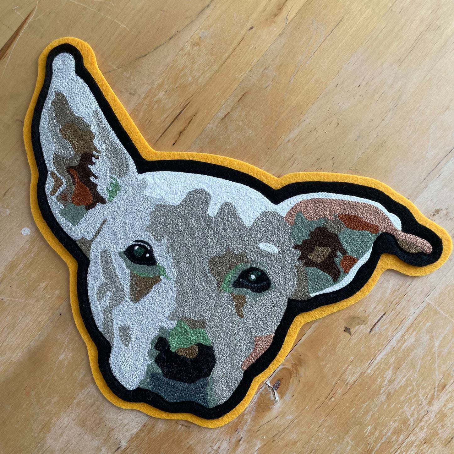 Handmade Handcranked Chainstitch Embroidered Custom Pet Portrait Patch - LARGE - chainstitch embroidered white dog on black and gold felt, made in Philadelphia PA