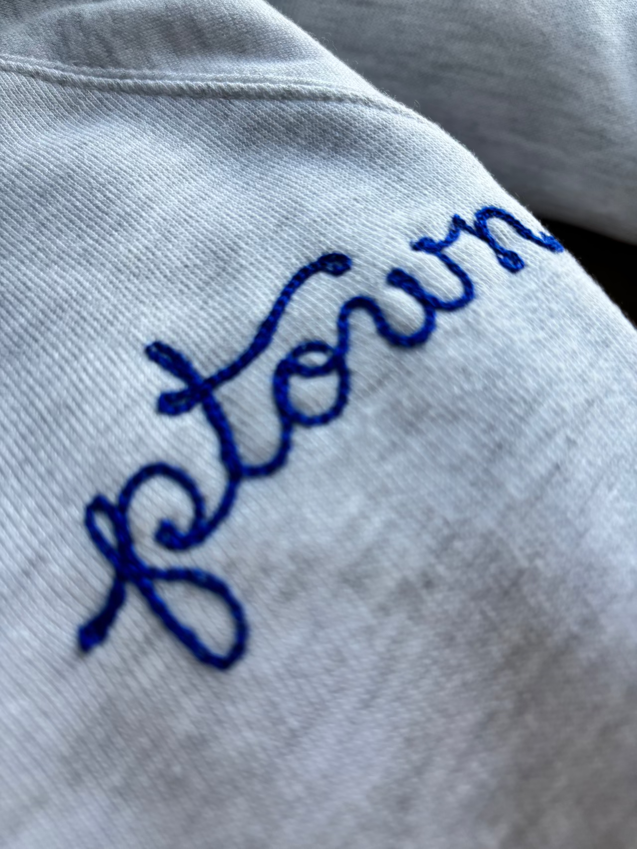 A custom chainstitch embroidered sweatshirt that says "ptown"